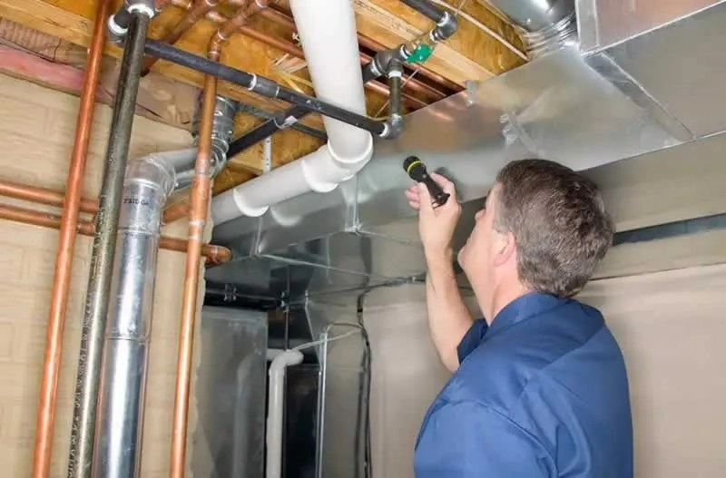 An engineer is inspecting the home's plumbing and pipe lines leaks