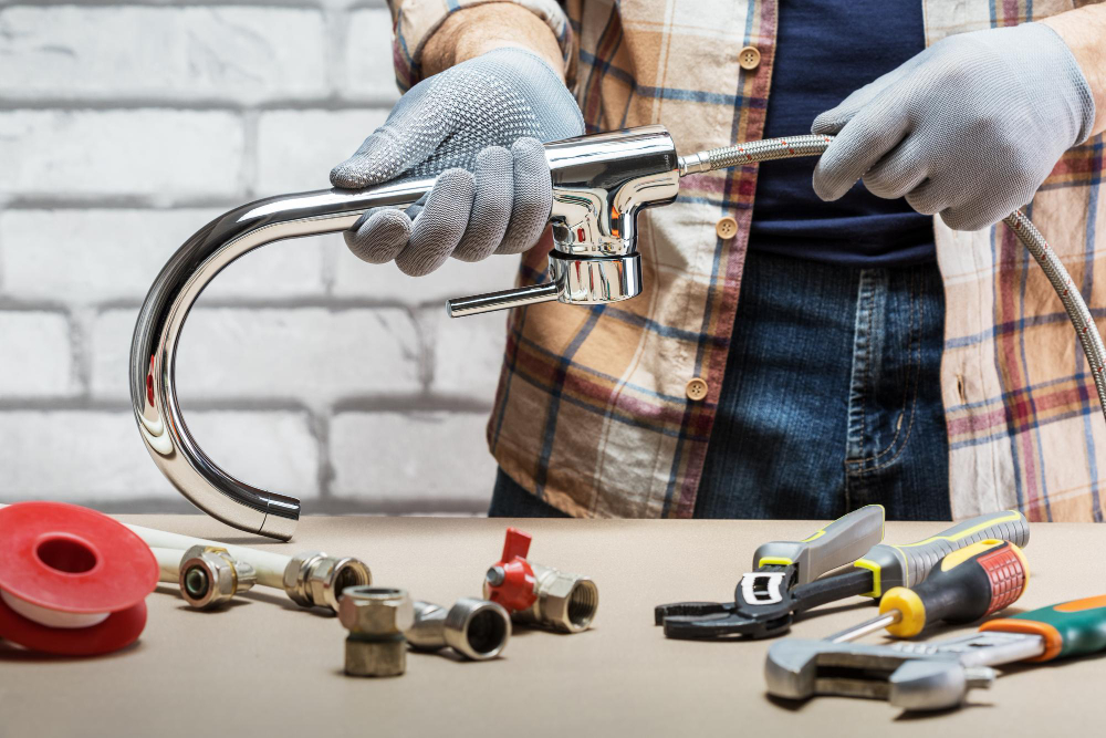 A worker is assembling the set of faucet