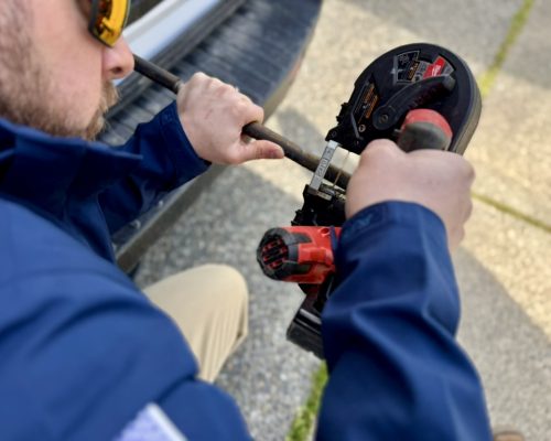 A plumber is busy on cutting tubes